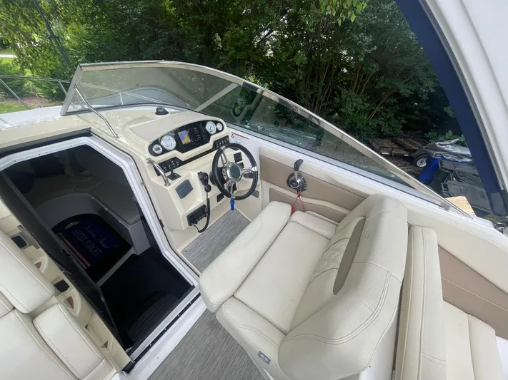  Yacht Photos Pics 2019 Regal 28 Express boat interior with steering wheel and dashboard controls.