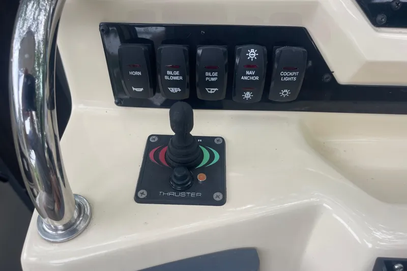  Yacht Photos Pics Control panel of a 2019 Regal 28 Express boat with switches and thruster joystick.