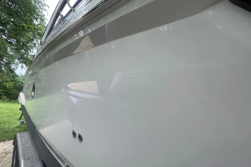  Yacht Photos Pics 2019 Regal 28 Express boat side view, showcasing sleek design and glossy finish.