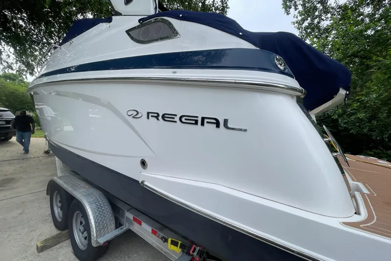  Yacht Photos Pics 2019 Regal 28 Express boat on trailer, side view with logo visible.