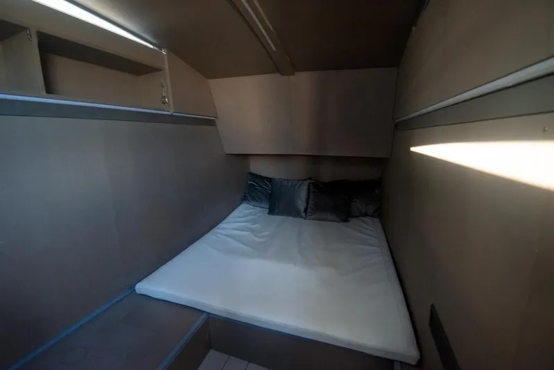  Yacht Photos Pics Cozy cabin interior of 2025 Sardine Marine Custom Race 55 yacht with bed and cushions.