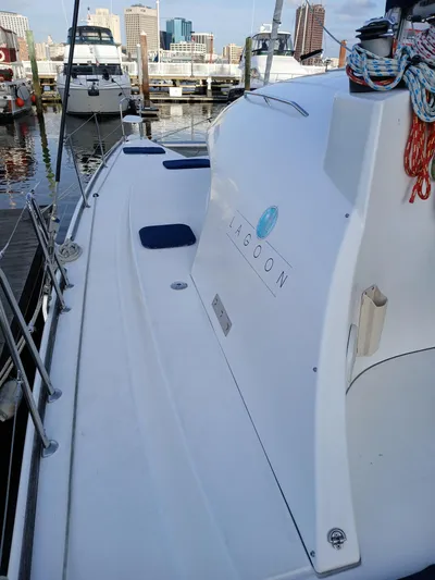 Double Diamond Yacht Photos Pics 2007 Lagoon 380 S2 catamaran docked at marina with city skyline.