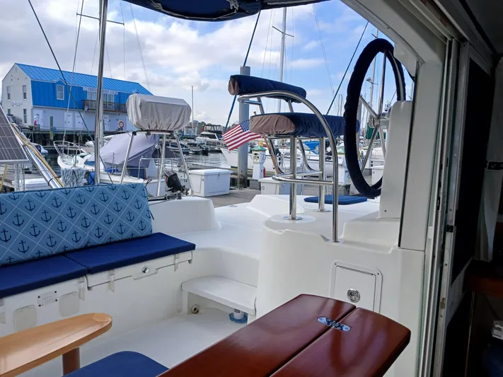 Double Diamond Yacht Photos Pics 2007 Lagoon 380 S2 catamaran interior with blue seating, docked at marina.