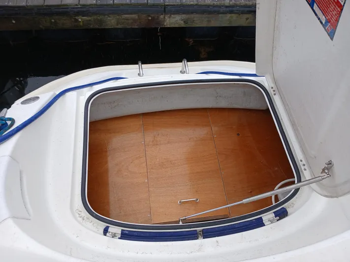 Double Diamond Yacht Photos Pics Open storage compartment on 2007 Lagoon 380 S2 boat, featuring wooden flooring.