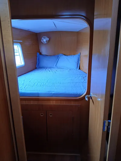 Double Diamond Yacht Photos Pics Cozy cabin interior of 2007 Lagoon 380 S2 catamaran with bed and wooden finish.