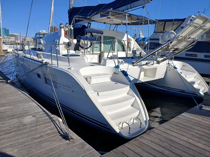 Double Diamond Yacht Photos Pics 2007 Lagoon 380 S2 catamaran docked at marina under clear blue sky.