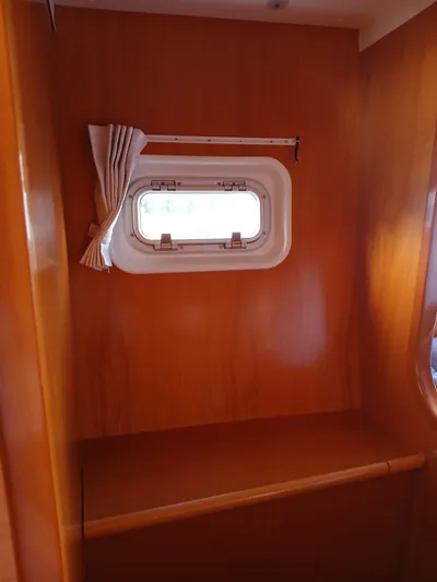 Double Diamond Yacht Photos Pics 2007 Lagoon 380 S2 interior with wooden finish and small window.