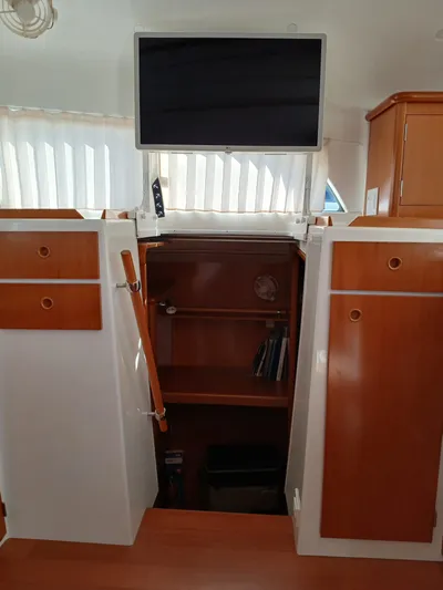 Double Diamond Yacht Photos Pics Interior of 2007 Lagoon 380 S2 catamaran with wooden cabinets and a mounted TV.