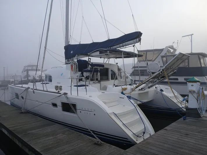 Double Diamond Yacht Photos Pics 2007 Lagoon 380 S2 catamaran docked in a foggy marina setting.