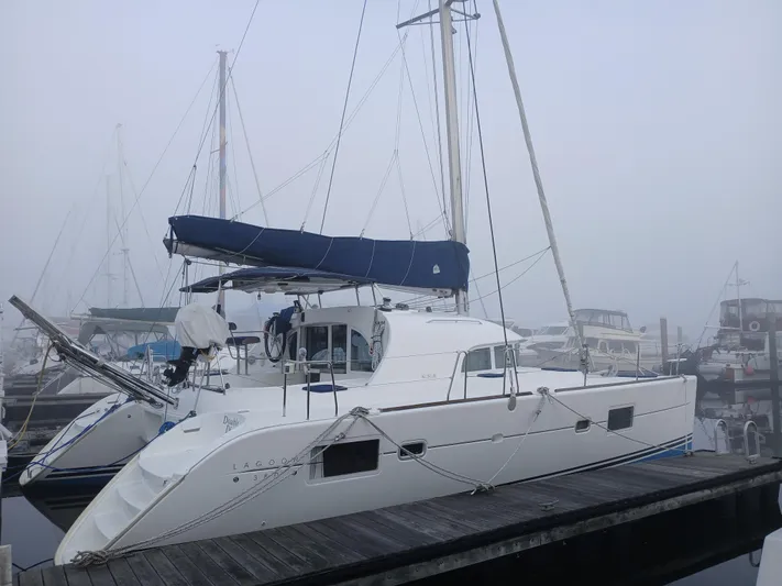 Double Diamond Yacht Photos Pics 2007 Lagoon 380 S2 catamaran docked in a foggy marina.
