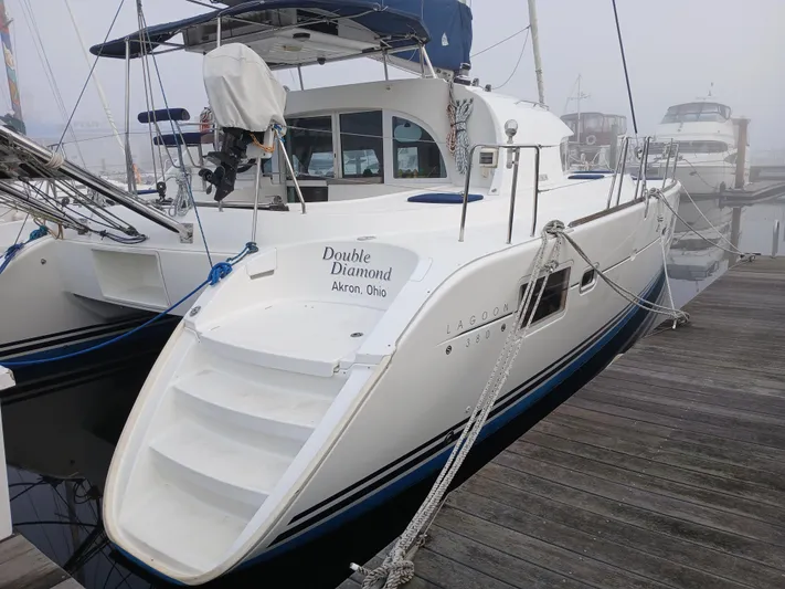 Double Diamond Yacht Photos Pics 2007 Lagoon 380 S2 catamaran docked, named "Double Diamond," with visible stern and boarding steps.