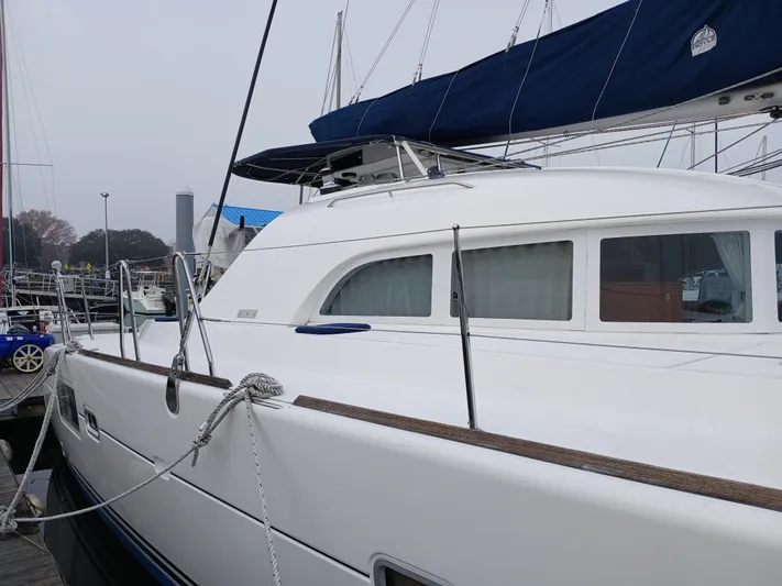 Double Diamond Yacht Photos Pics 2007 Lagoon 380 S2 catamaran docked at a marina, featuring sleek white design.