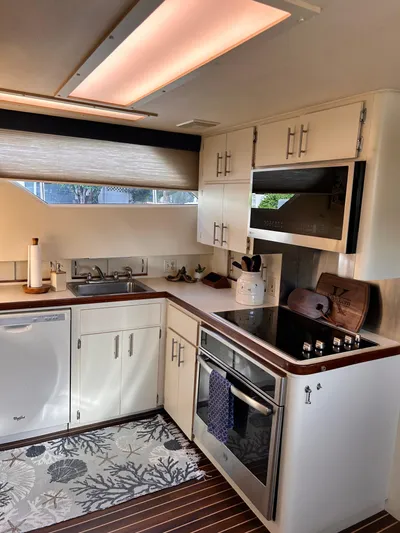 Hatty Shack Yacht Photos Pics Modern kitchen in 1989 Hatteras 67 Cockpit Motor Yacht with sleek appliances and wood accents.