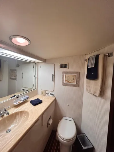 Hatty Shack Yacht Photos Pics 1989 Hatteras 67 Cockpit Motor Yacht bathroom with sink, toilet, and mirror.