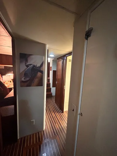 Hatty Shack Yacht Photos Pics Interior hallway of 1989 Hatteras 67 Cockpit Motor Yacht with wood flooring.