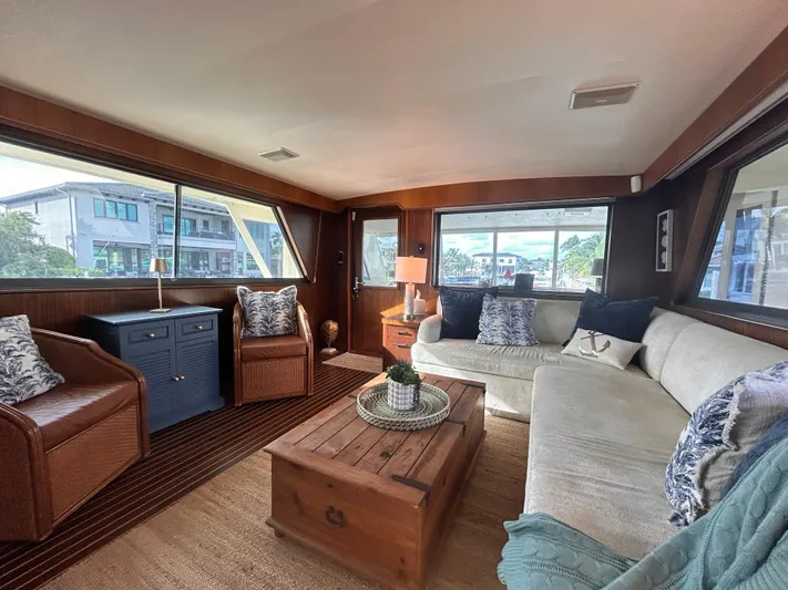 Hatty Shack Yacht Photos Pics Luxurious interior of 1989 Hatteras 67 Cockpit Motor Yacht with cozy seating and wooden accents.