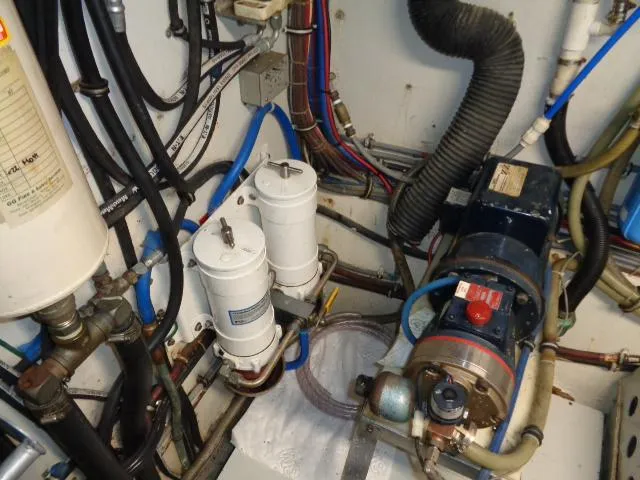 Hatty Shack Yacht Photos Pics Engine room of 1989 Hatteras 67 Cockpit Motor Yacht with filters and machinery.