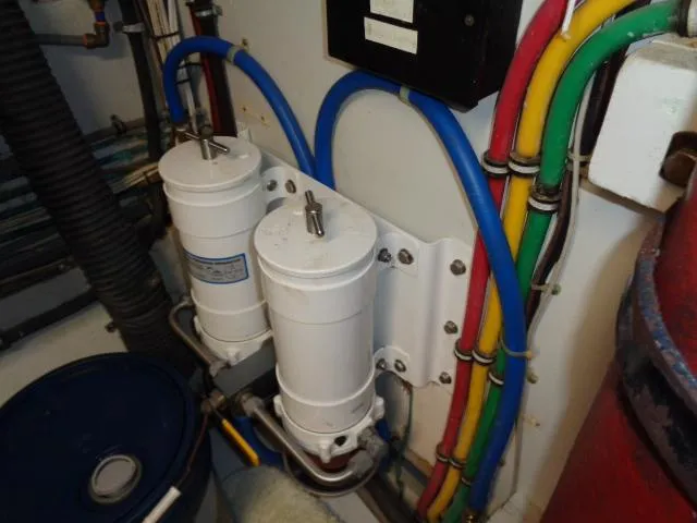 Hatty Shack Yacht Photos Pics Engine room of 1989 Hatteras 67 Cockpit Motor Yacht with filters and colorful wiring.