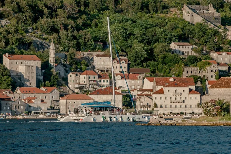 Tahiti Yacht Photos Pics 2015 Fountaine Pajot TAHITI catamaran sailing near historic coastal village.