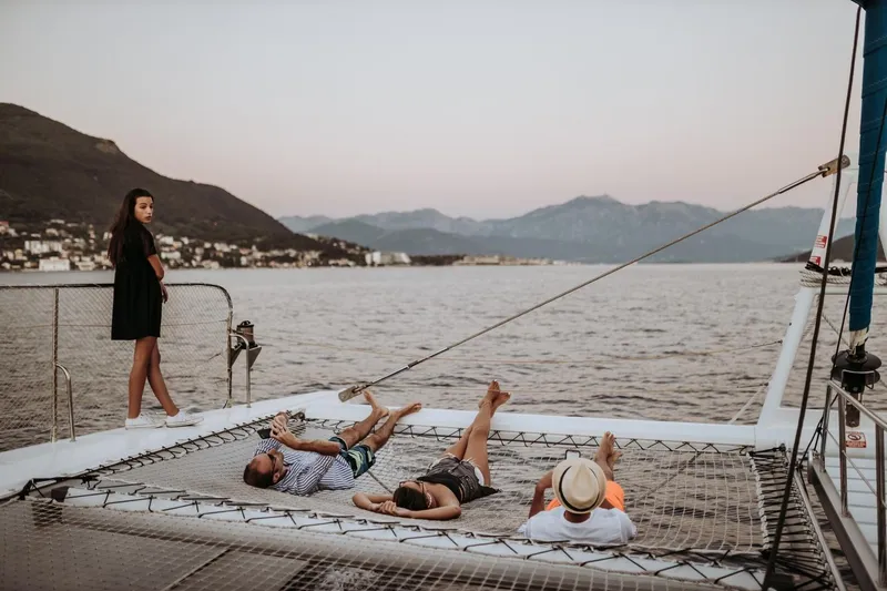 Tahiti Yacht Photos Pics People relaxing on a 2015 Fountaine Pajot TAHITI catamaran, enjoying scenic ocean views.