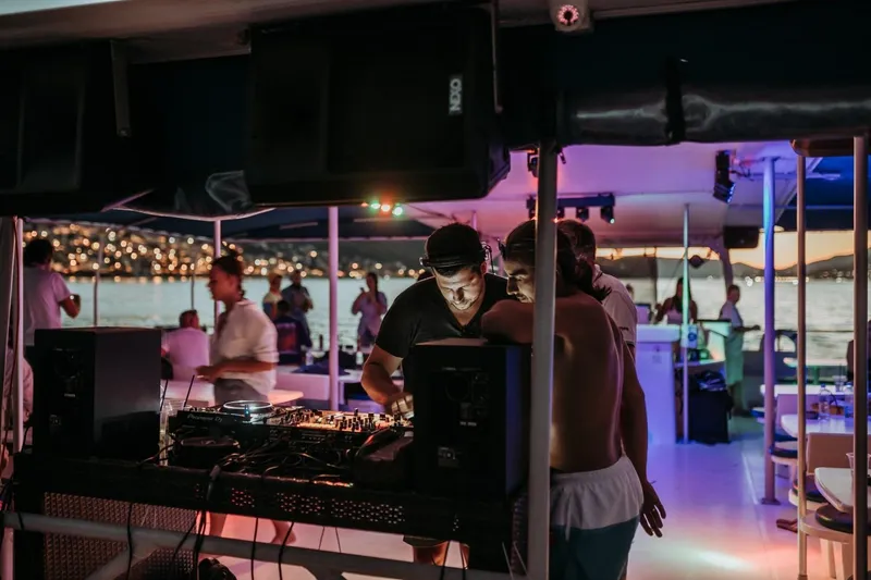 Tahiti Yacht Photos Pics Party on Fountaine Pajot TAHITI 2015 yacht with DJ and guests at sunset.