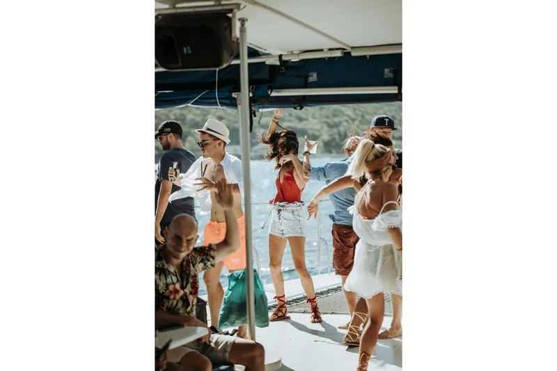 Tahiti Yacht Photos Pics People dancing on a 2015 Fountaine Pajot TAHITI catamaran, enjoying a lively party atmosphere.