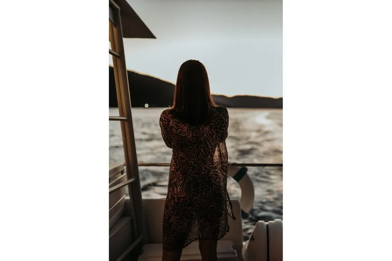 Tahiti Yacht Photos Pics Woman enjoying sunset on 2015 Fountaine Pajot TAHITI yacht, overlooking serene waters.