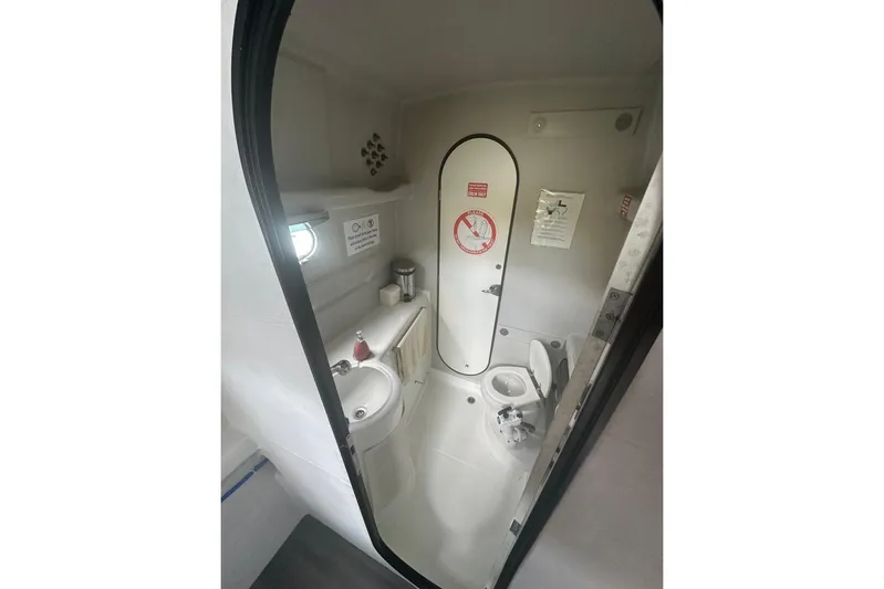 Tahiti Yacht Photos Pics Compact bathroom in 2015 Fountaine Pajot TAHITI yacht, featuring sink and toilet.
