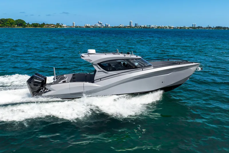  Yacht Photos Pics 2025 Novielli SERE boat cruising on blue ocean near city skyline.