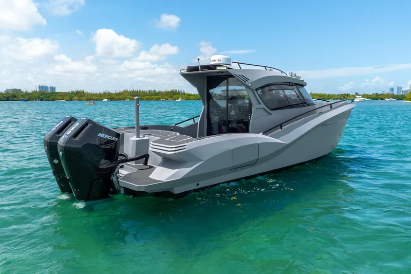 Yacht Photos Pics 2025 Novielli SERE boat on clear blue water, featuring dual Mercury engines.