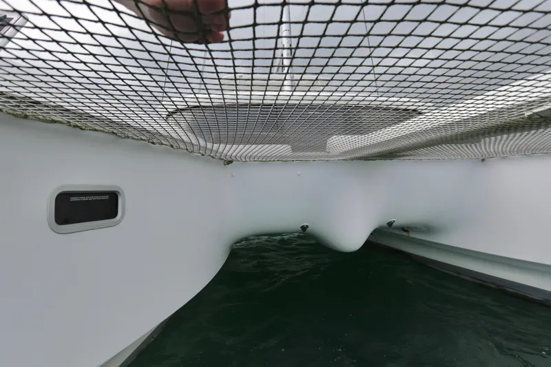 Babur Yacht Photos Pics View of the netting and hull of a 2021 Lagoon 46 catamaran.