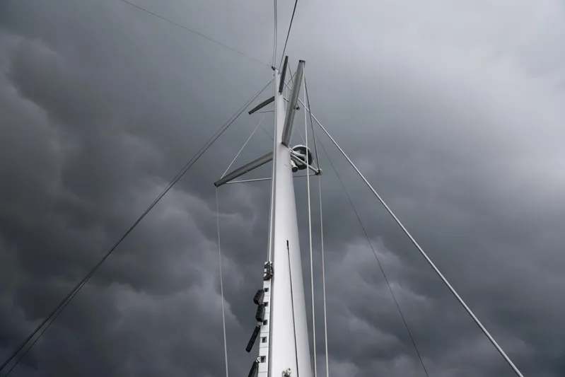 Babur Yacht Photos Pics Lagoon 46 sailboat mast against stormy sky, 2021 model.