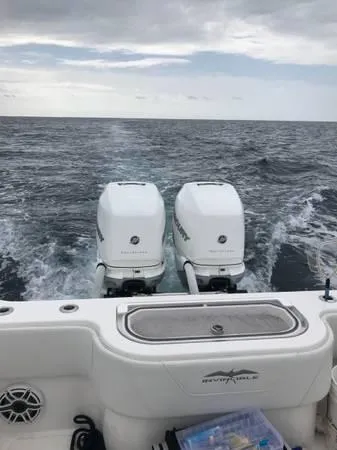  Yacht Photos Pics 2020 Invincible 33 Open Fisherman boat with twin outboard motors on the ocean.