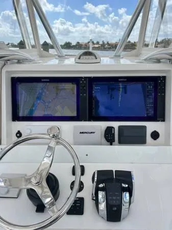  Yacht Photos Pics 2020 Invincible 33 Open Fisherman dashboard with dual navigation screens and steering wheel.