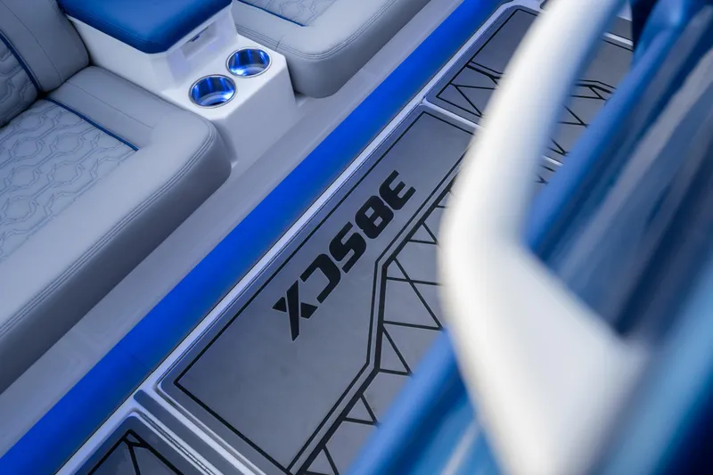  Yacht Photos Pics 2026 Fountain 38 SCX boat interior with blue accents and cup holders.