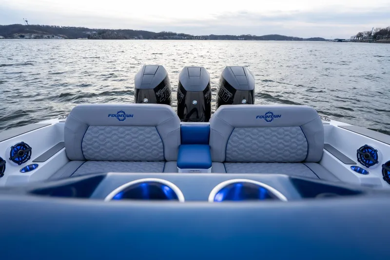  Yacht Photos Pics 2026 Fountain 38 SCX boat with triple engines on a calm lake.