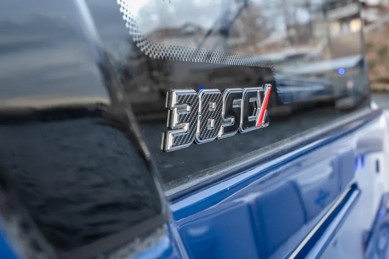  Yacht Photos Pics Close-up of 2026 Fountain 38 SCX boat logo on blue exterior.