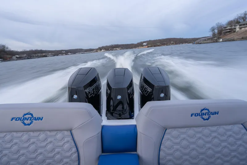  Yacht Photos Pics 2026 Fountain 38 SCX boat with triple engines speeding on a lake.