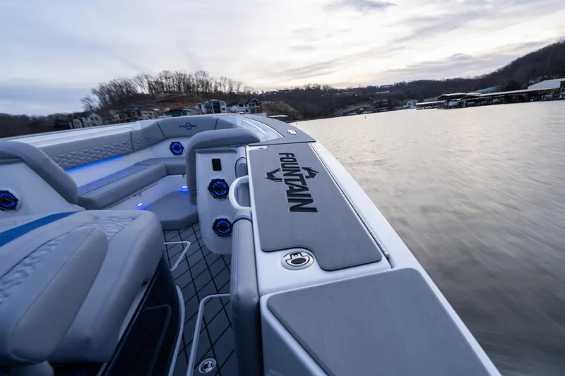  Yacht Photos Pics 2026 Fountain 38 SCX boat interior with sleek seating and modern design on a calm lake.