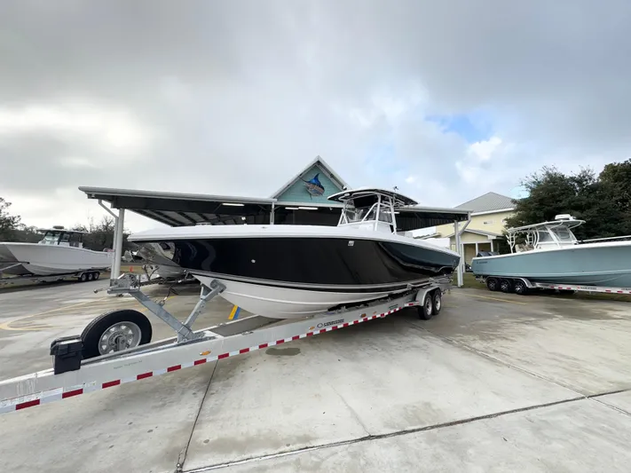  Yacht Photos Pics 2018 Fountain 34 CC boat on trailer, parked outdoors under cloudy sky.