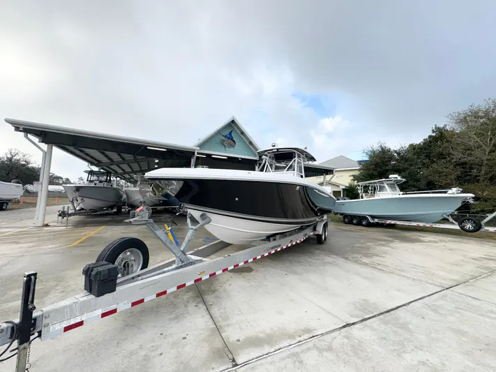  Yacht Photos Pics 2018 Fountain 34 CC boat on trailer in marina parking lot.