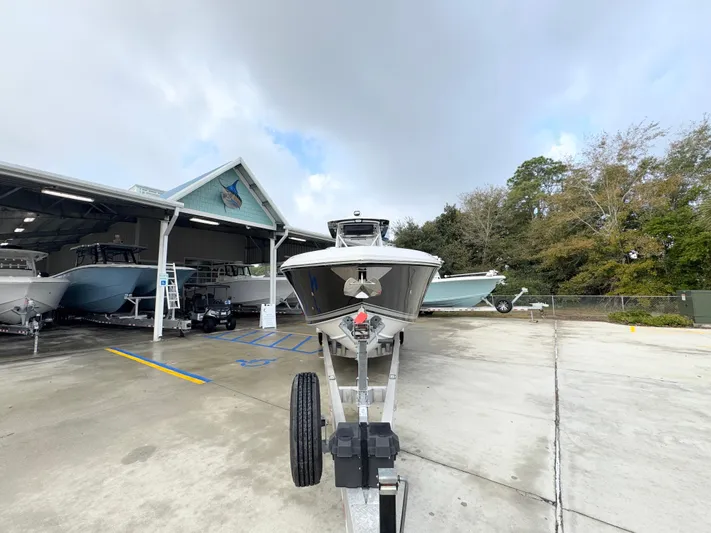  Yacht Photos Pics 2018 Fountain 34 CC boat on trailer at marina, cloudy sky background.