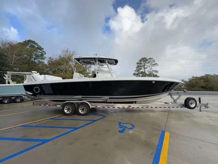 Yacht Photos Pics 2018 Fountain 34 CC boat on trailer in parking lot.