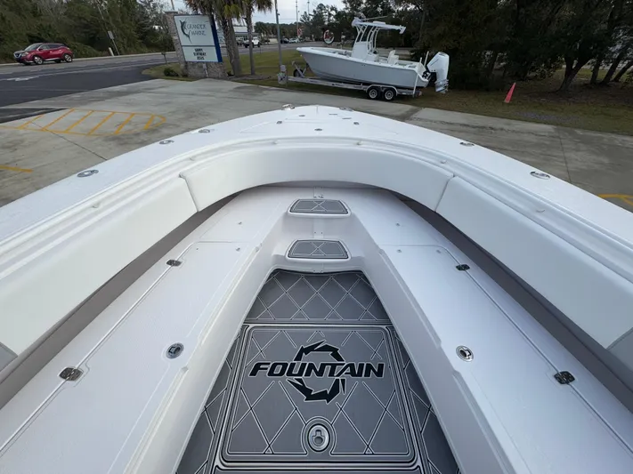  Yacht Photos Pics 2018 Fountain 34 CC boat deck with logo, parked on a trailer.
