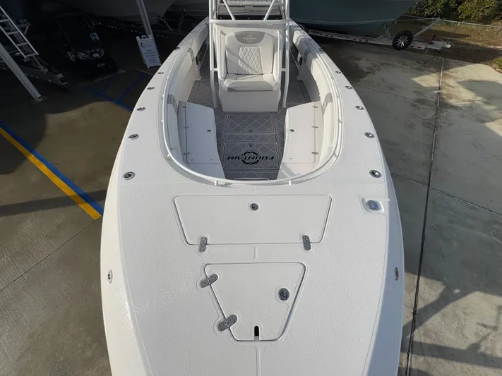  Yacht Photos Pics 2018 Fountain 34 CC boat, top view, white deck, parked on concrete.