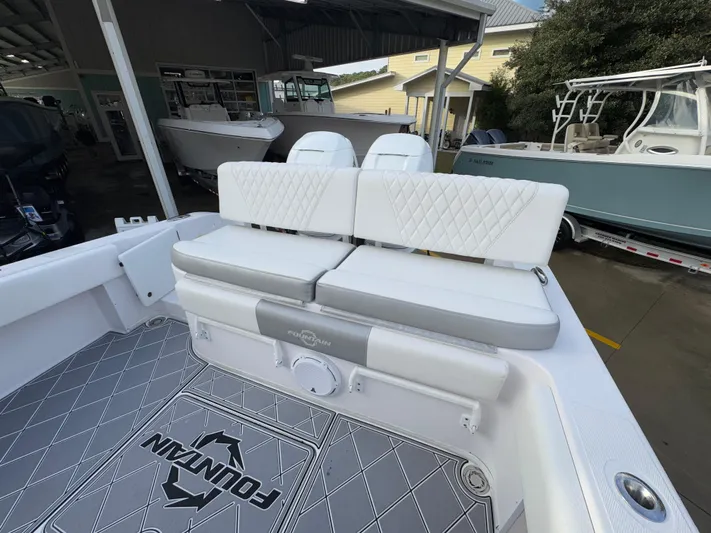  Yacht Photos Pics 2018 Fountain 34 CC boat interior with cushioned seating and logo flooring.