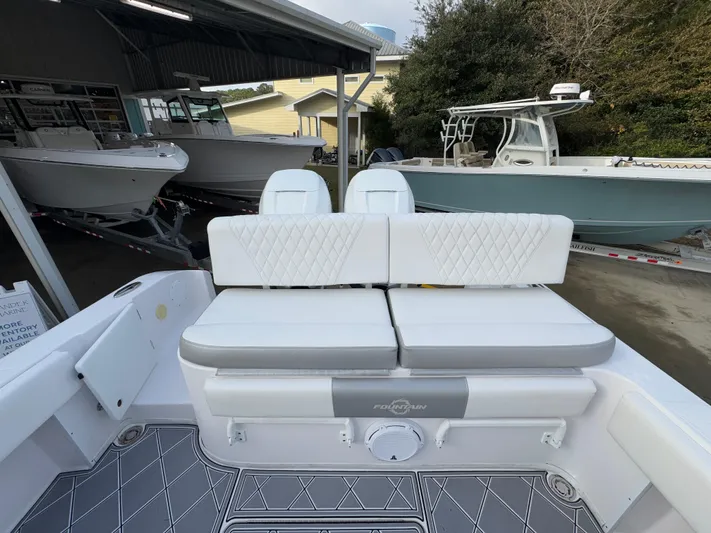  Yacht Photos Pics 2018 Fountain 34 CC boat interior with white cushioned seating and sleek design.