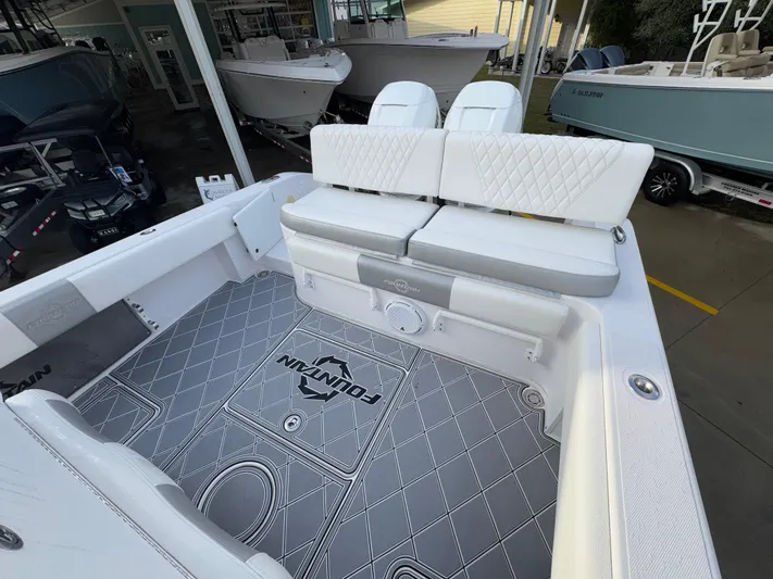  Yacht Photos Pics 2018 Fountain 34 CC boat interior with white seating and custom flooring.