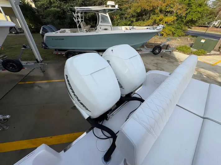  Yacht Photos Pics 2018 Fountain 34 CC boat with twin Mercury outboard engines, parked on a trailer.