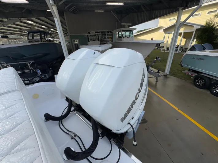  Yacht Photos Pics 2018 Fountain 34 CC boat with dual Mercury outboard engines in a covered marina.